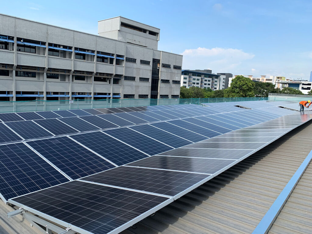 worker checking solar panel on rooftop