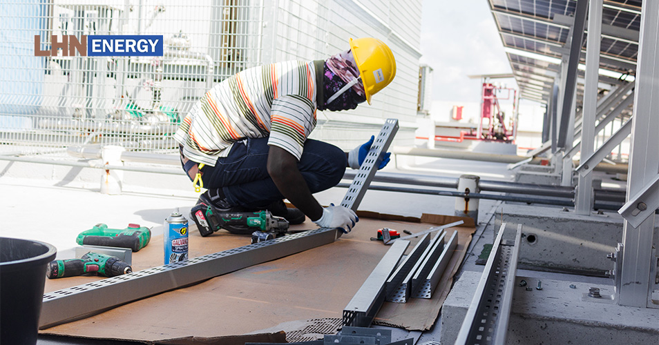 Worker installing solar panel racking for LHN Energy.