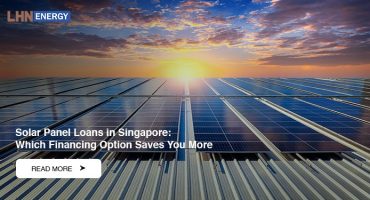 Rows of solar panels installed on a metal rooftop under a vibrant sunset with orange and blue clouds.