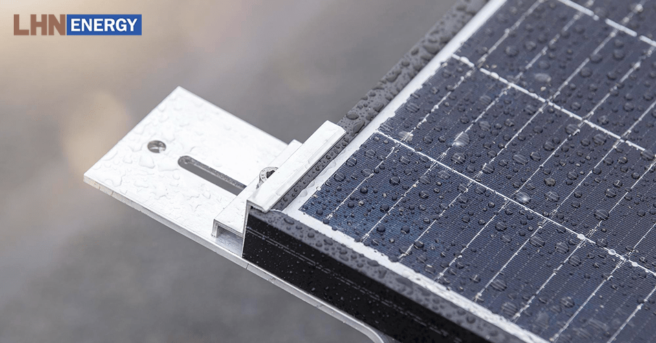 Close-up of solar panel mounting hardware and rain droplets.