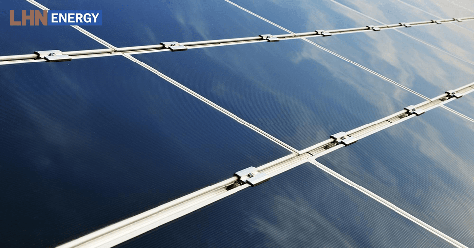 Close-up of thin-film solar panels reflecting the sky.