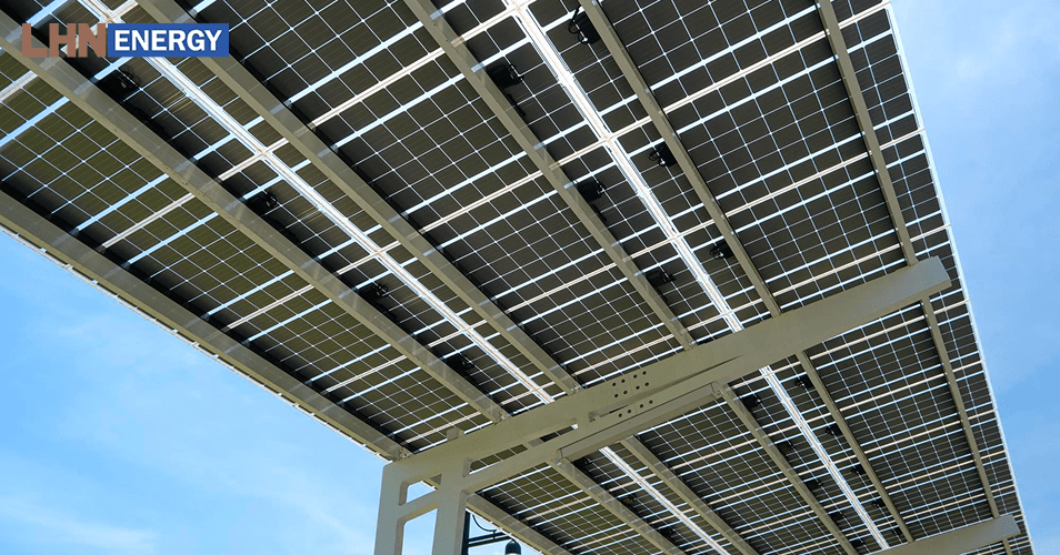 Underneath view of bifacial solar panels capturing light.