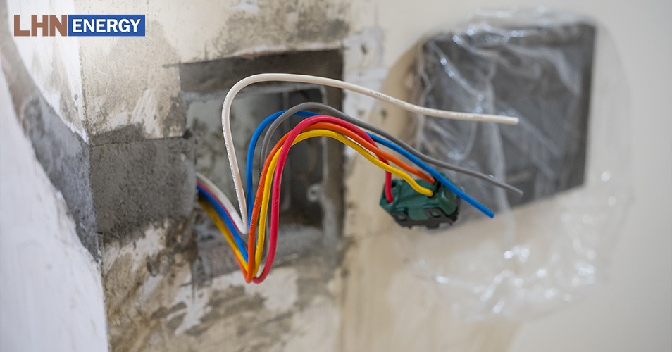 Exposed electrical wiring in a wall during maintenance.